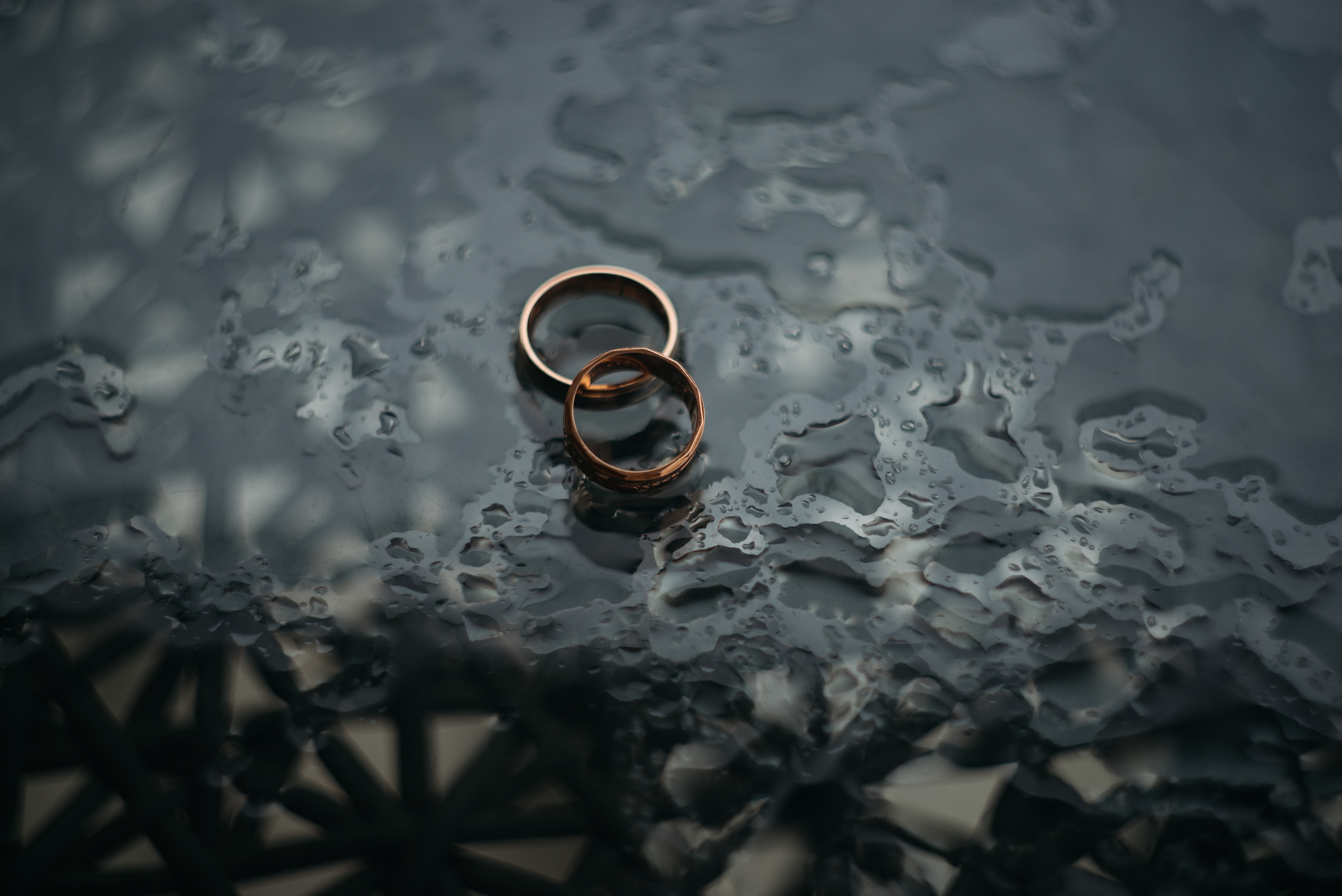 Two wedding rings in the rain representing divorce